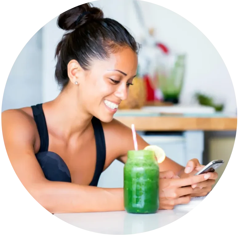 Woman holding green wellness drink for energy focus and biohacking