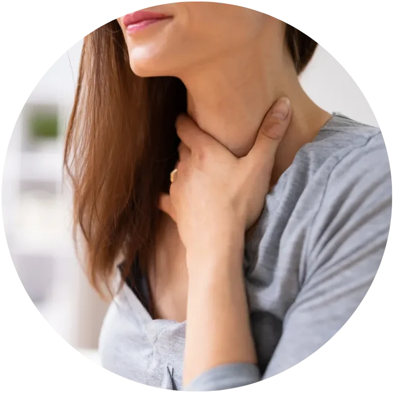 Woman touching neck for thyroid health and hormone wellness concerns