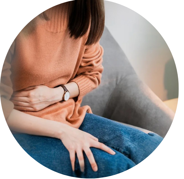 Woman holding stomach for digestive system health concerns