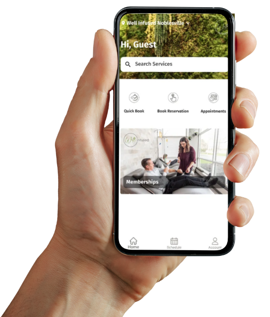 Hand holding Well Infused mobile app for booking appointments