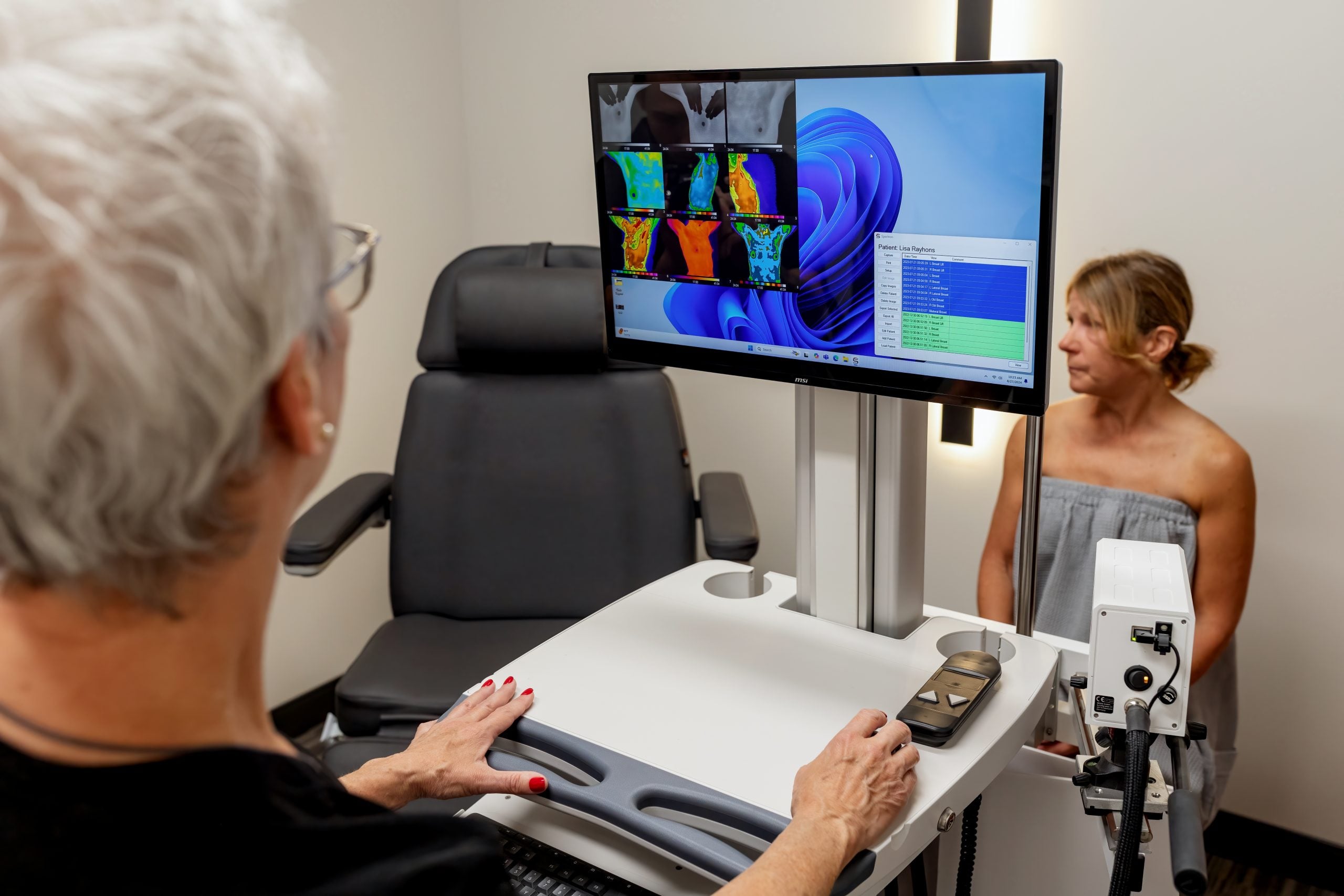 Thermography screening consultation with thermal image on monitor