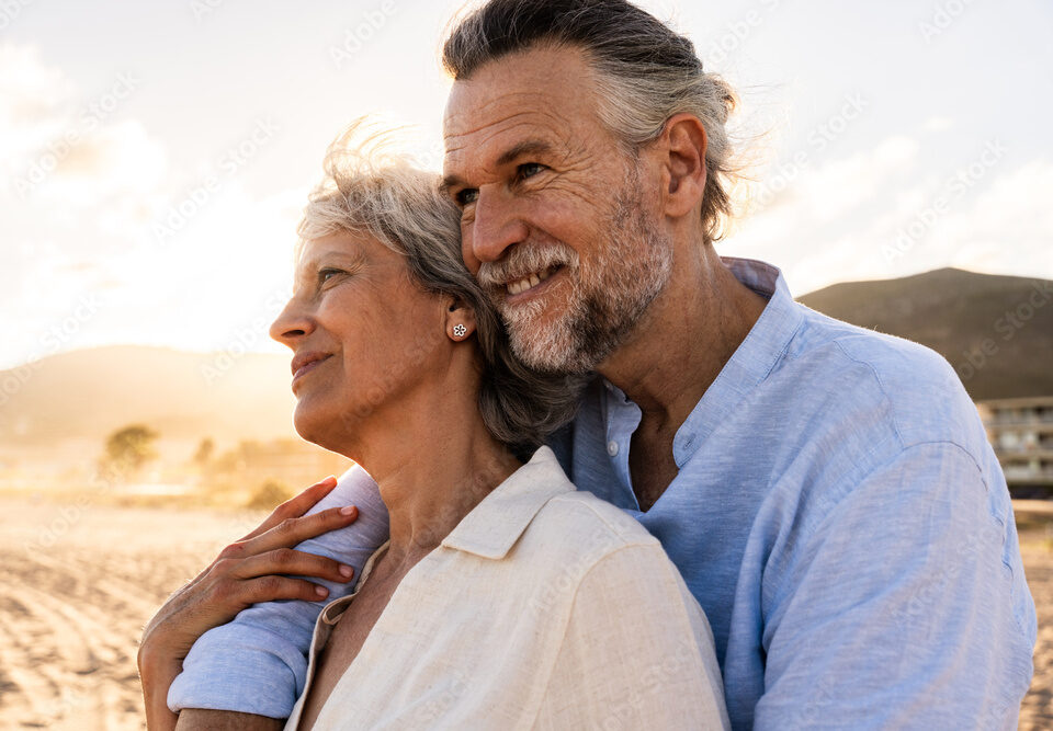 Smiling mature couple outdoors for hormone and peptide wellness support