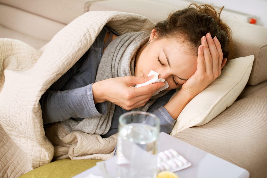 Woman resting in bed representing immune system support